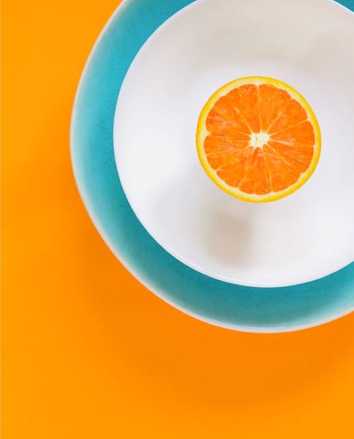 Half orange on a plate