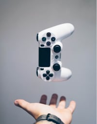 A hand catching a gaming console controller