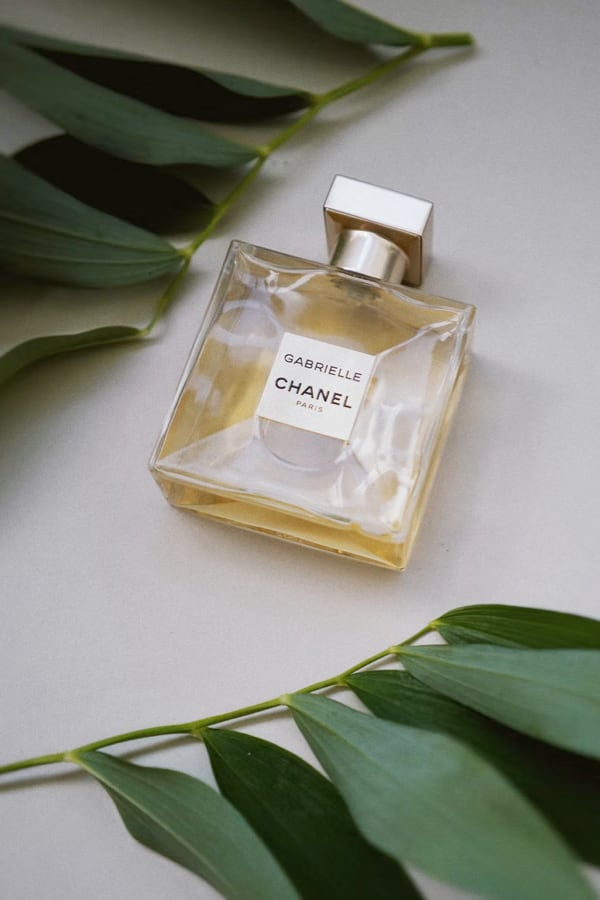 Bottle of perfume with plants around